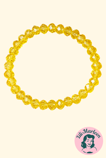 Emely – Elastisk Armbånd med Gule Facetperler - Gennemsigtige